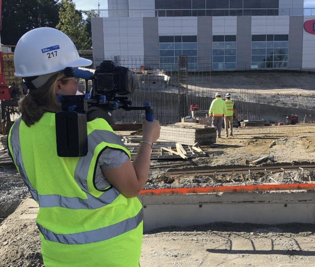behind the scenes of Emma of Emma Lula Creative shooting a video on a construction site