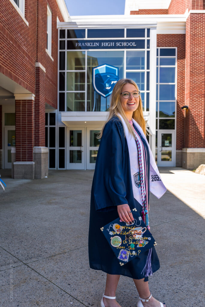 Graduate portrait photography session of student in cap and gown at Franklin High School in Franklin, MA.