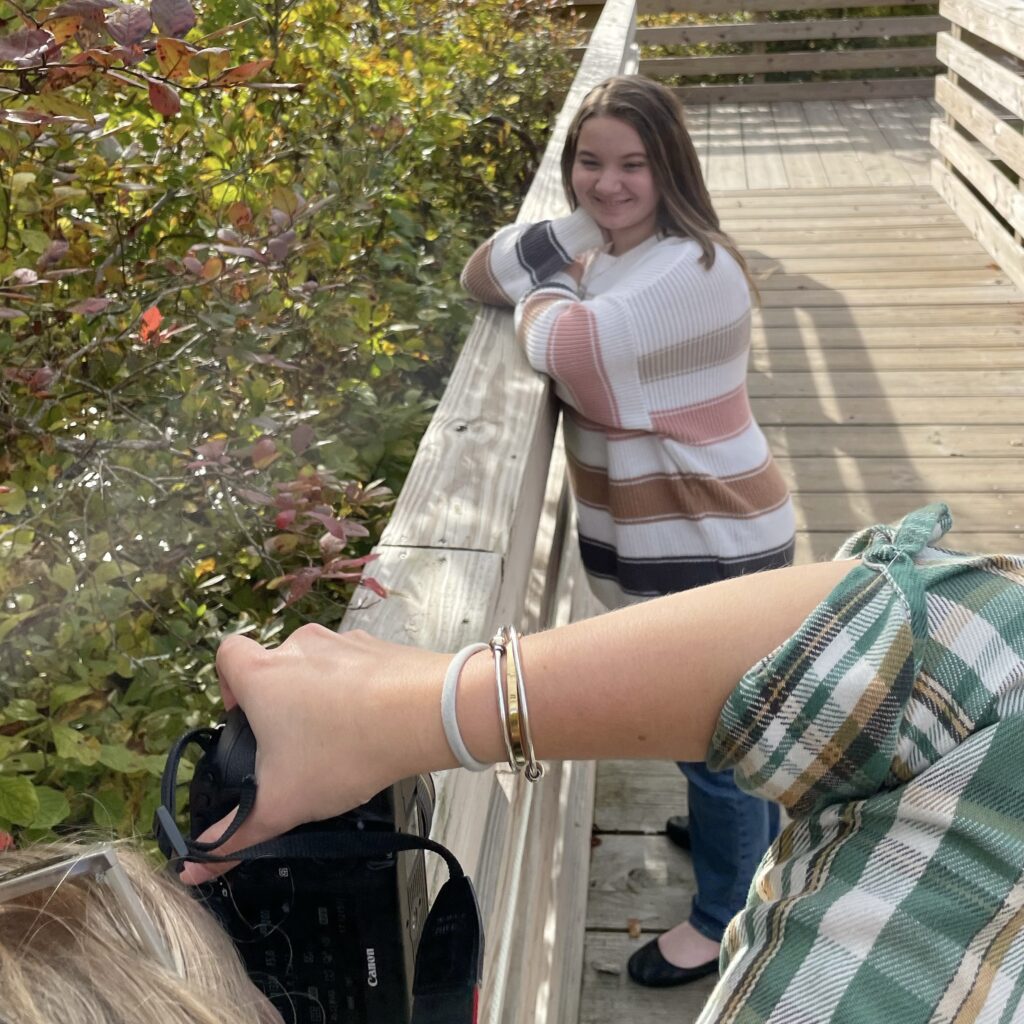 Photographer taking photo of girl in Behind the scenes of Emma Lula Creative Senior Photography Session in Norfolk, Massachusetts.