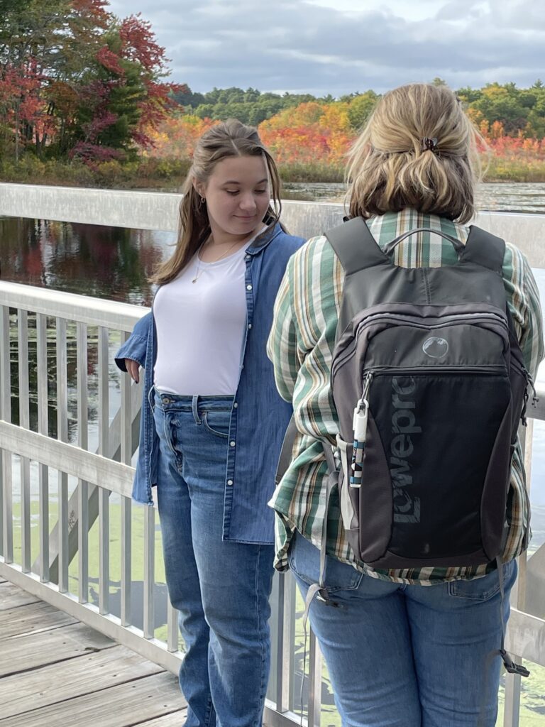 Photographer taking photo of girl in Behind the scenes of Emma Lula Creative Senior Photography Session in Norfolk, Massachusetts.