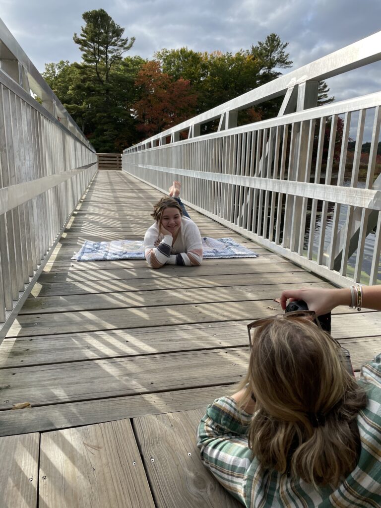 Photographer taking photo of girl in Behind the scenes of Emma Lula Creative Senior Photography Session in Norfolk, Massachusetts.