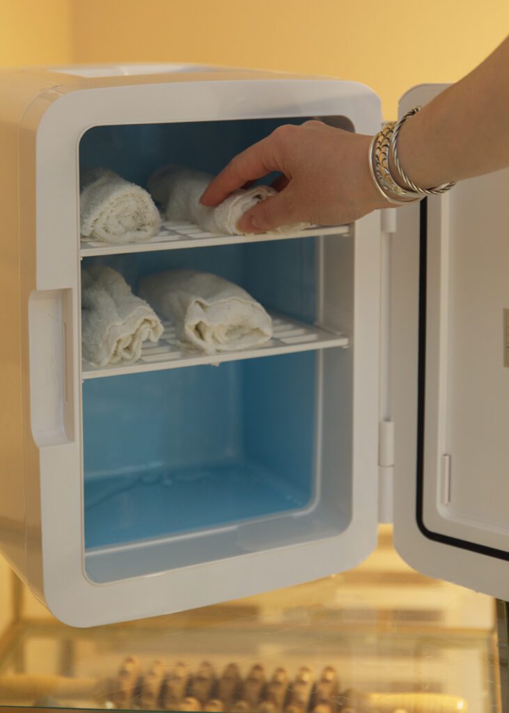 Mini refrigerator of cold towels for branding photography session.