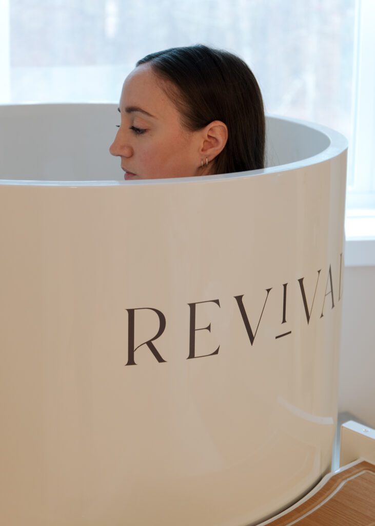 Woman in cold plunge for branding photography session in Revival Wellness Studio in Medfield, MA.