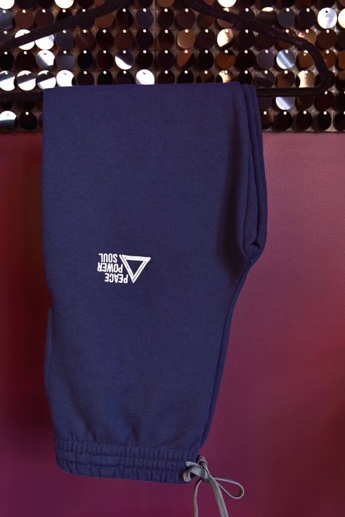 Pair of branded sweatpants hanging for fashion-inspired brand photography session for fitness studio apparel in Massachusetts.