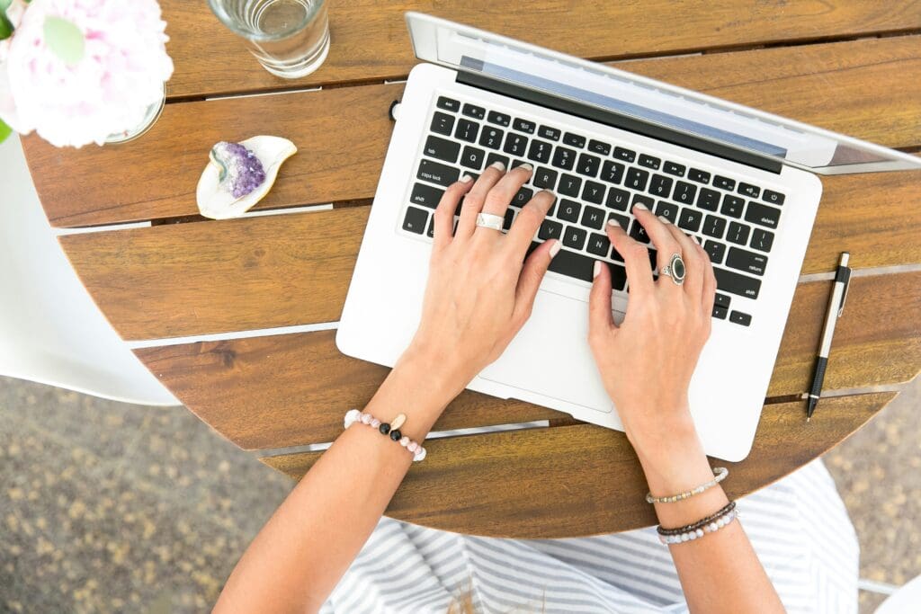 Stock photo of hands typing on laptop.
