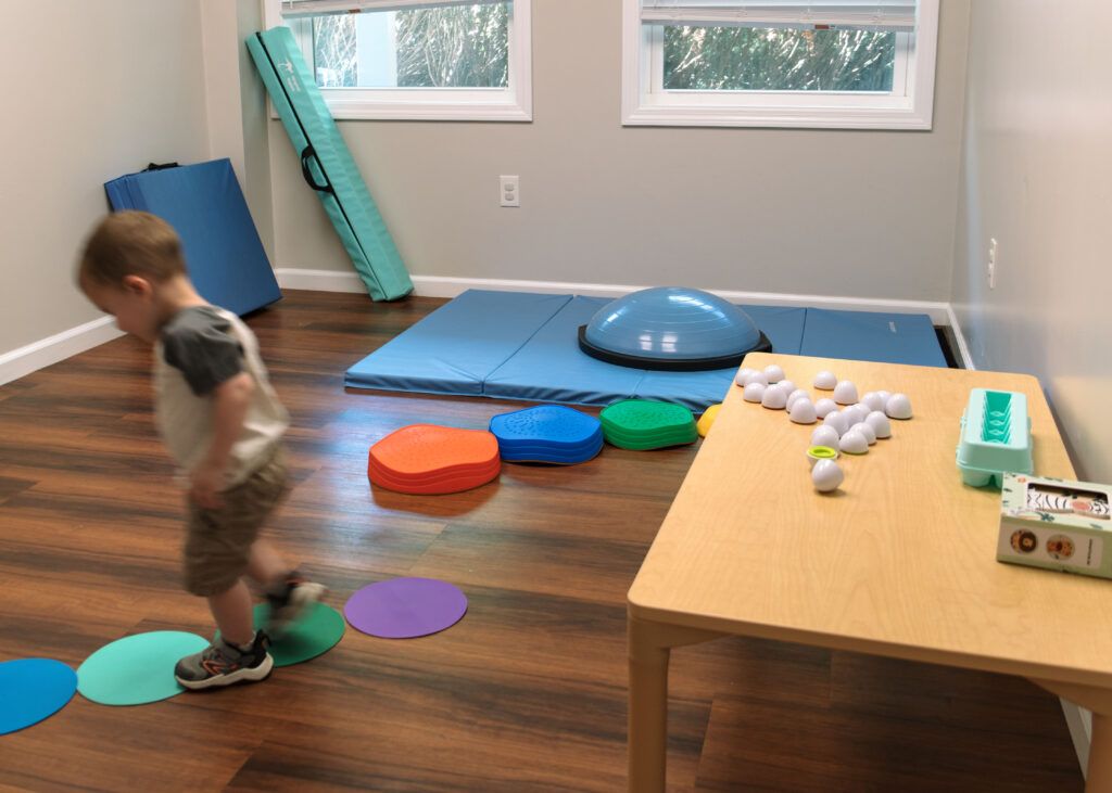 Raheb Physical Therapy brand photoshoot with child patient playing.